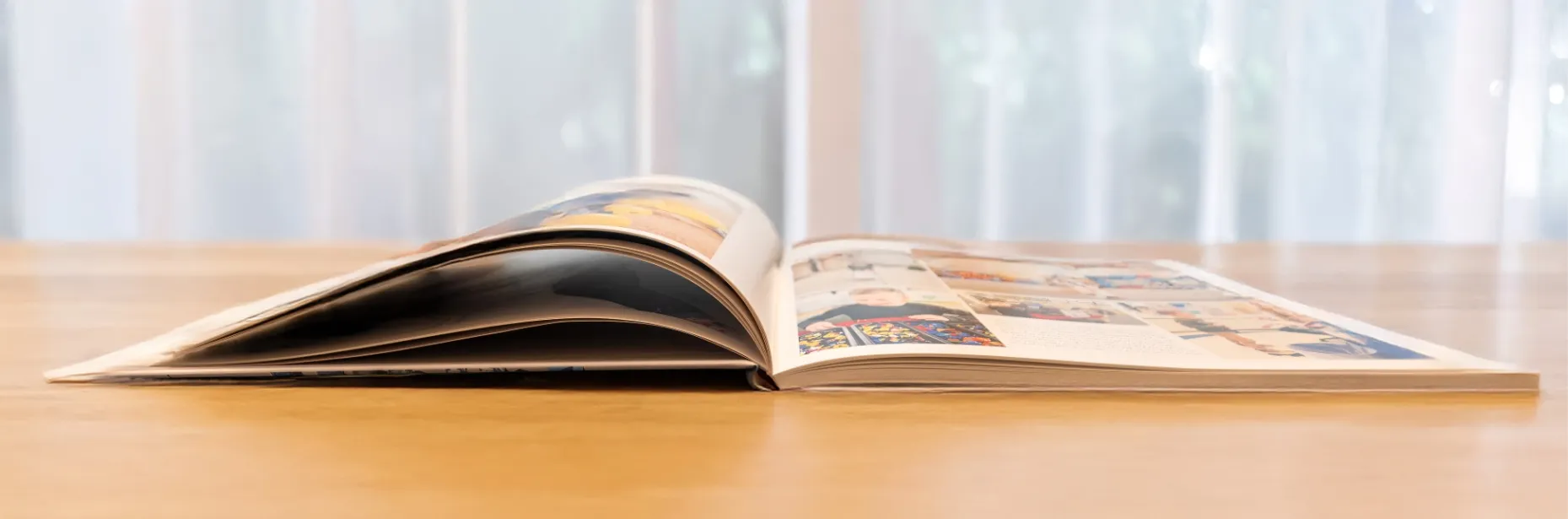 Custom printed photo book lying open, showing premium paper quality and vibrant color printing